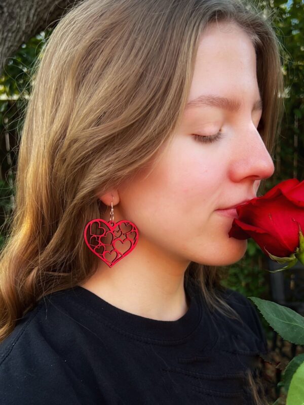 Elegant red Heart Wood Earrings perfect for a custom gift, displayed by a model.